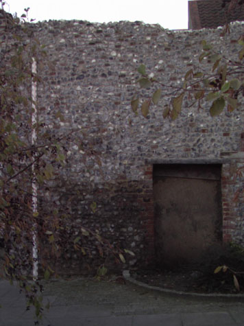 Outer face of wall between archway and blocked doorway