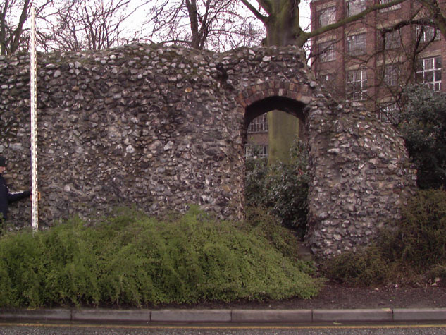 Doorway cut through the wall with brick arched head at the south end of the wall